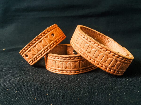 Brown stamped leather bracelets.