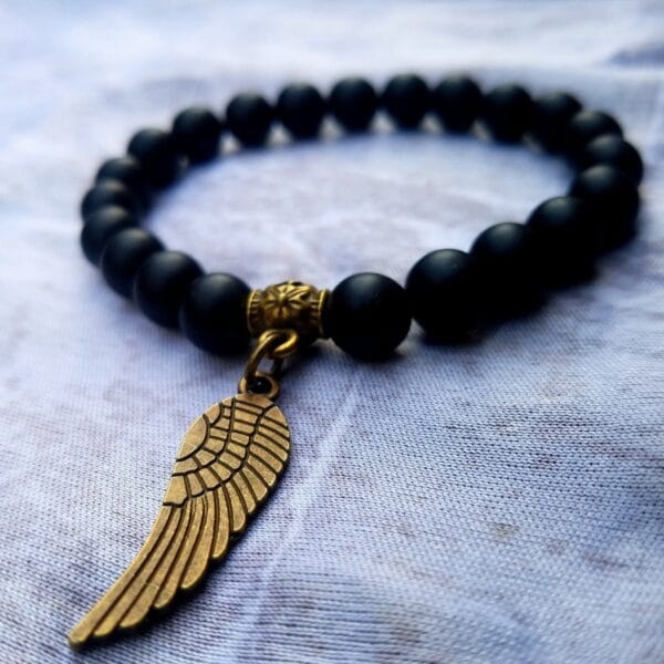 Black Onyx matte Bracelet - with a wing pendant Bronze